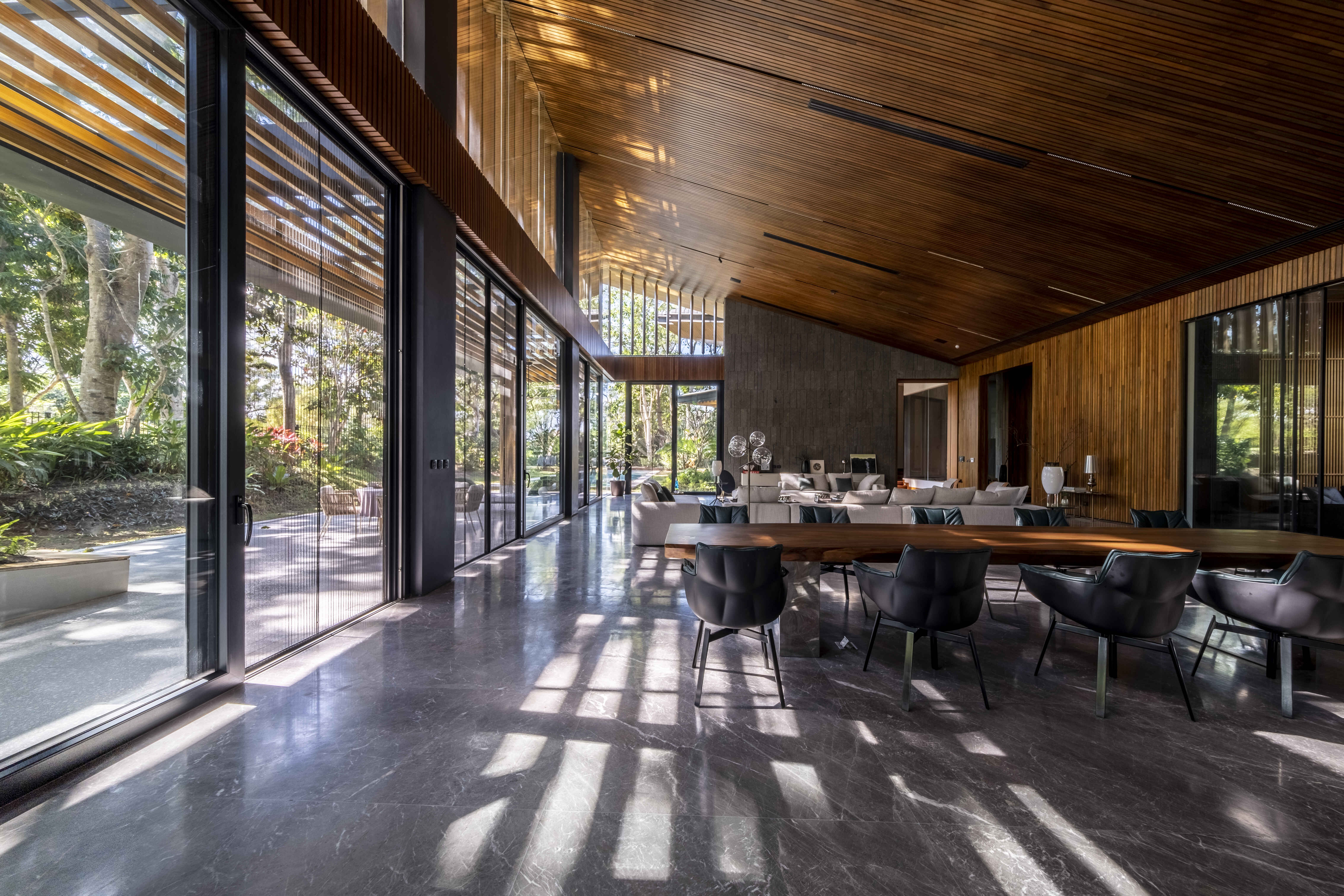 A sweeping view from the kitchen to the far end of the hall shows the different areas within the open plan space