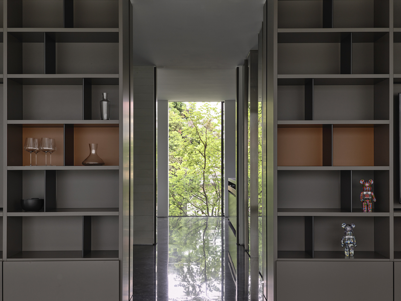 View from the living room looking toward the dining and dry kitchen area; the library uses Molteni 505 shelving.  