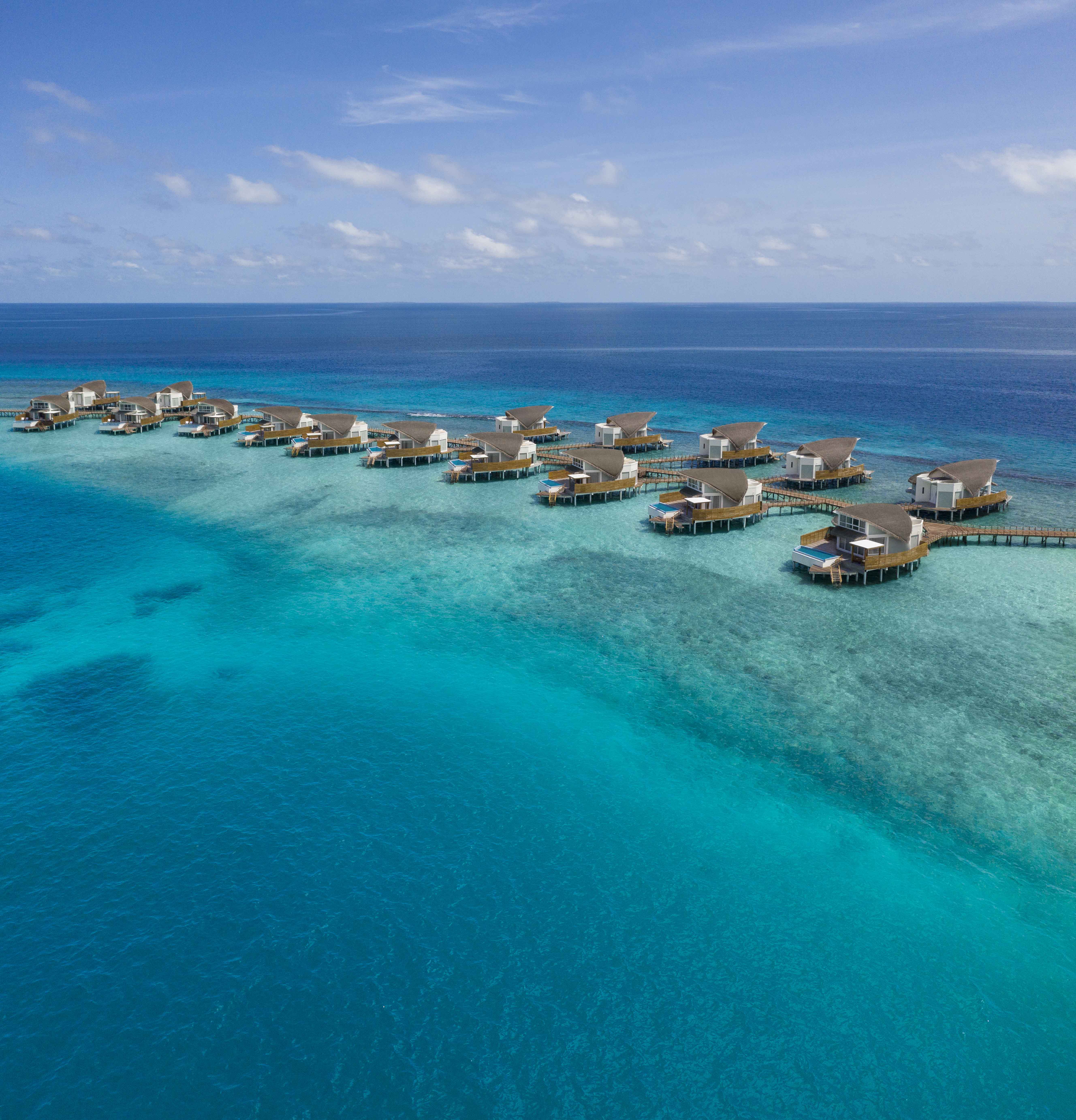 The team designed the overwater pool villas to resemble a group of native birds resting in shallow water 