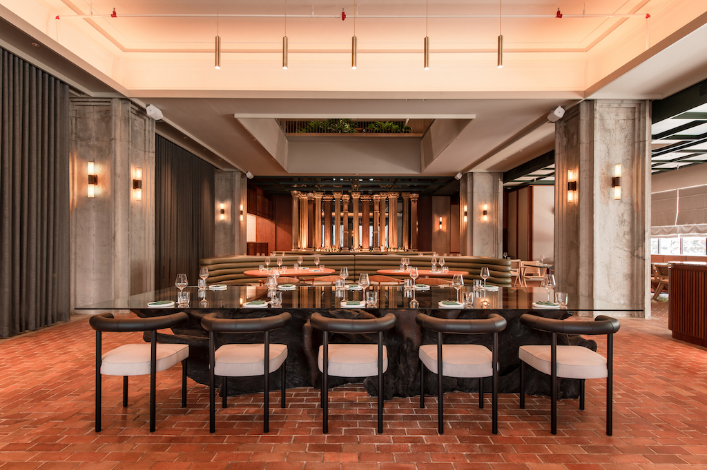 Raw Kitchen Hall’s bar area is framed by carved antique timber columns that were salvaged from Armenian mansions in India.