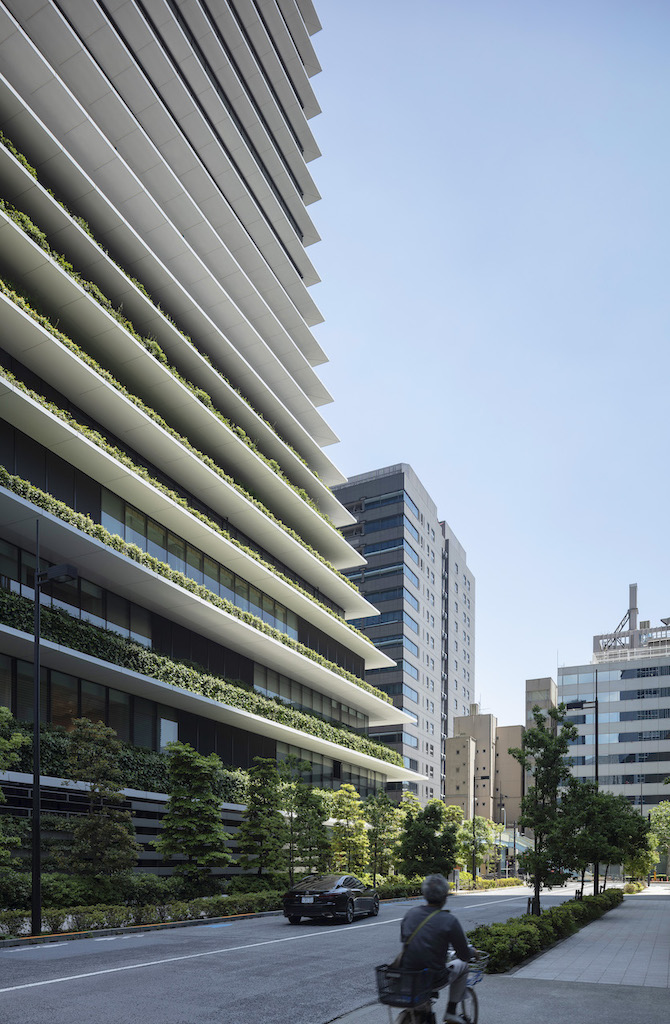 A vertical garden city with green roofs and facades.