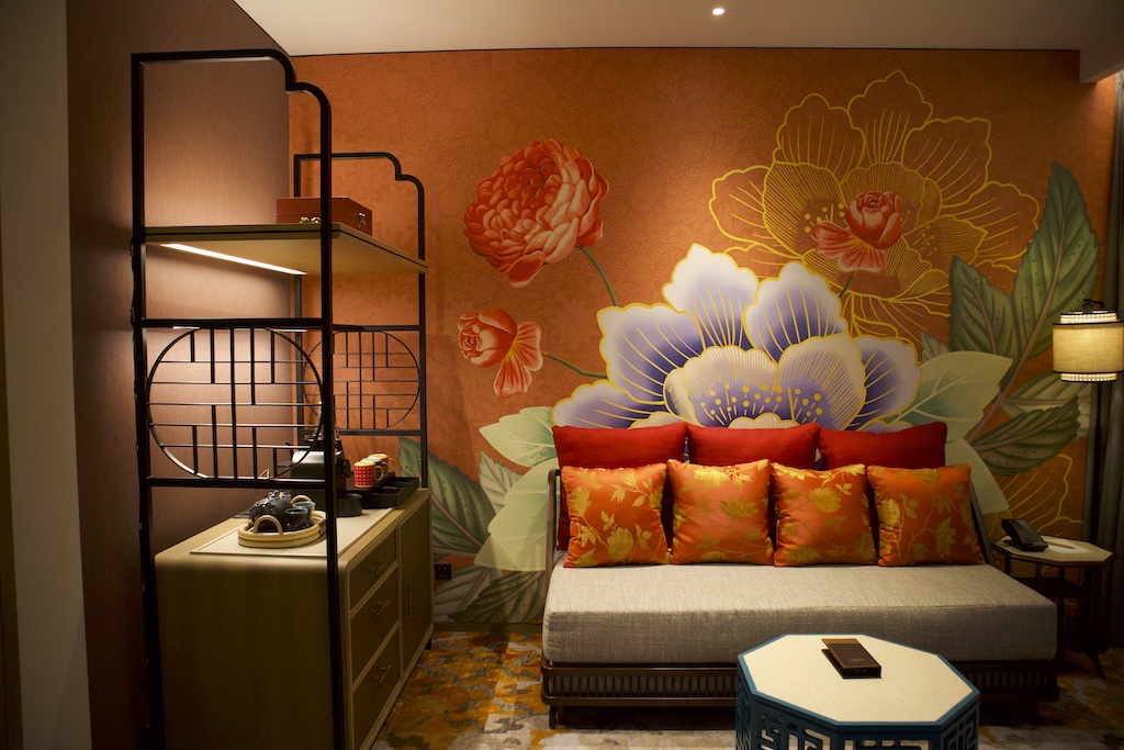 Design elements include colourful tiles, rattan furnishings, Chinese-style artworks, and rugs with traditional motifs.