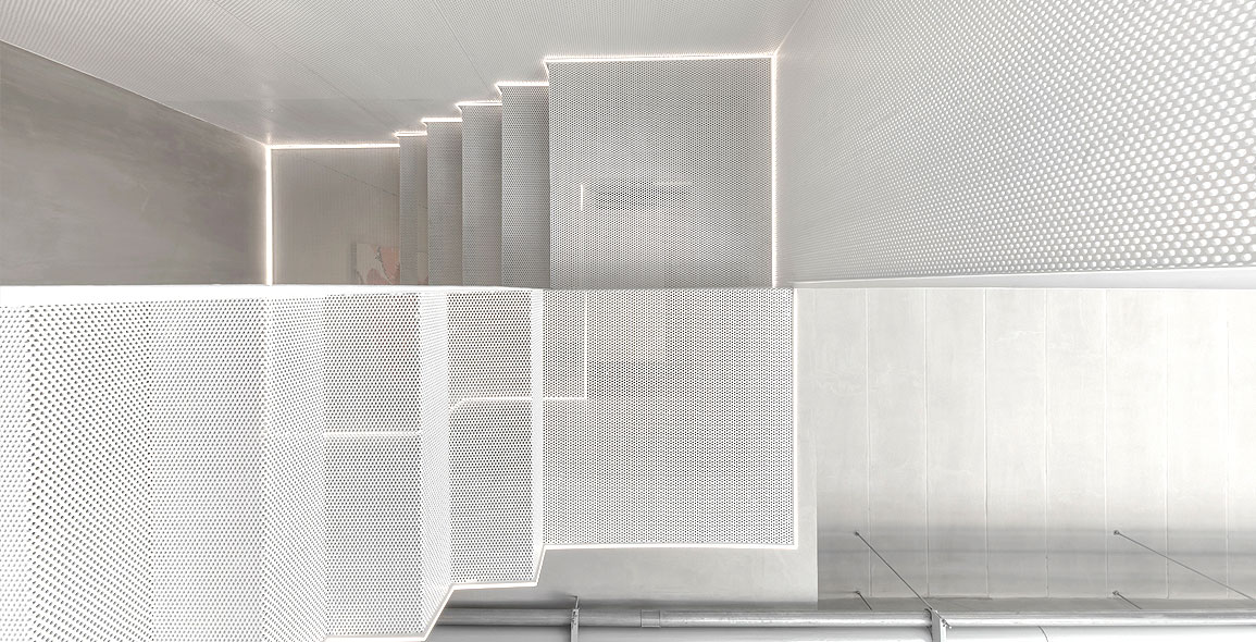 Inspired by Japanese origami, the “floating” interior staircase is made of thin, perforated steel sheets that were geometrically folded to make them stronger and more stable.